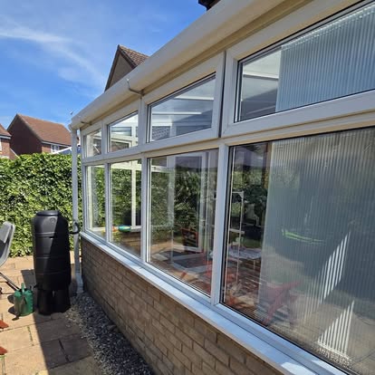 Side elevation of the conservatory showing white frames and glazed units